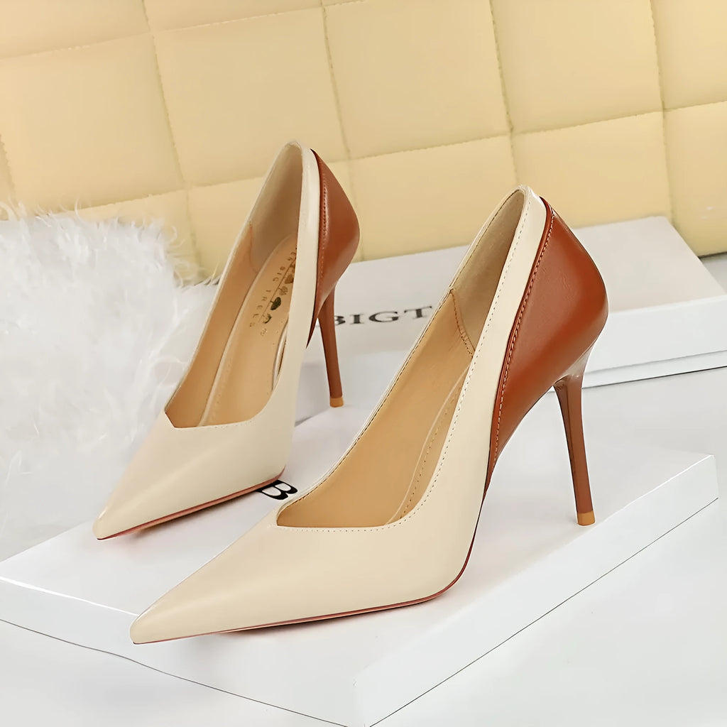 Women's black retro pumps with a pointed toe and high stiletto heel on a white background.