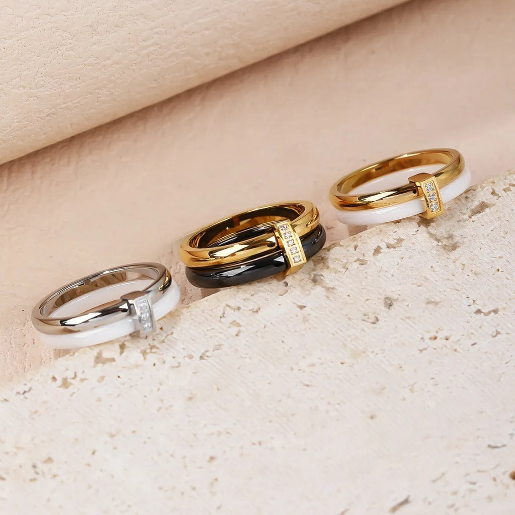 Heart shape titanium steel women's ring with double band, glossy stitching, and inlaid zirconium stones.