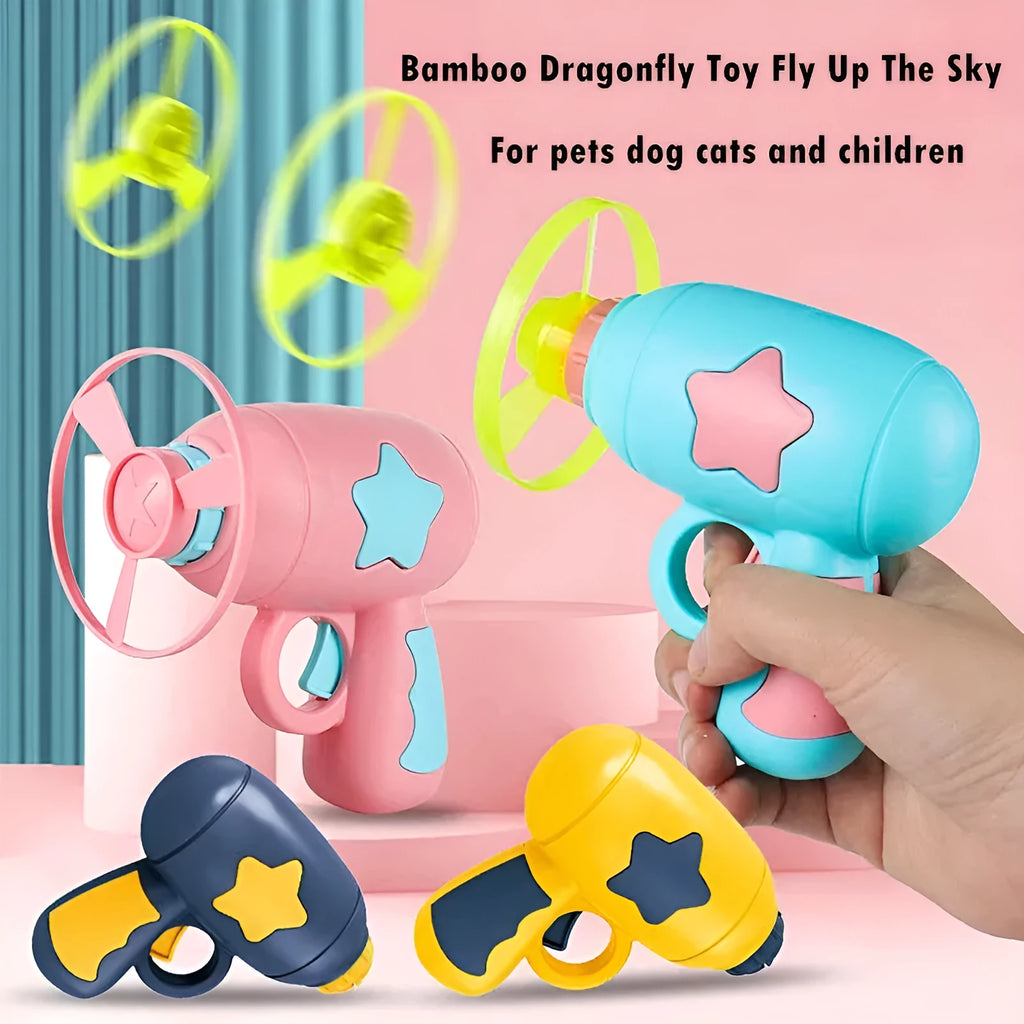 Plastic flying saucer launcher toy set with LED lights and coloured discs on outdoor grass.