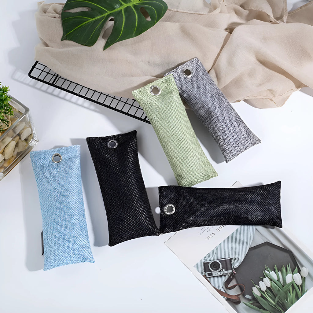 Four bamboo charcoal deodorising bags in black, green, grey and blue colours measuring 16.5cm x 6.5cm