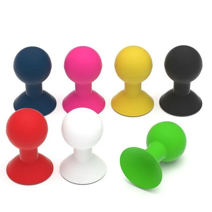 Silicone octopus ball mobile phone holder in blue holding a smartphone on a desk