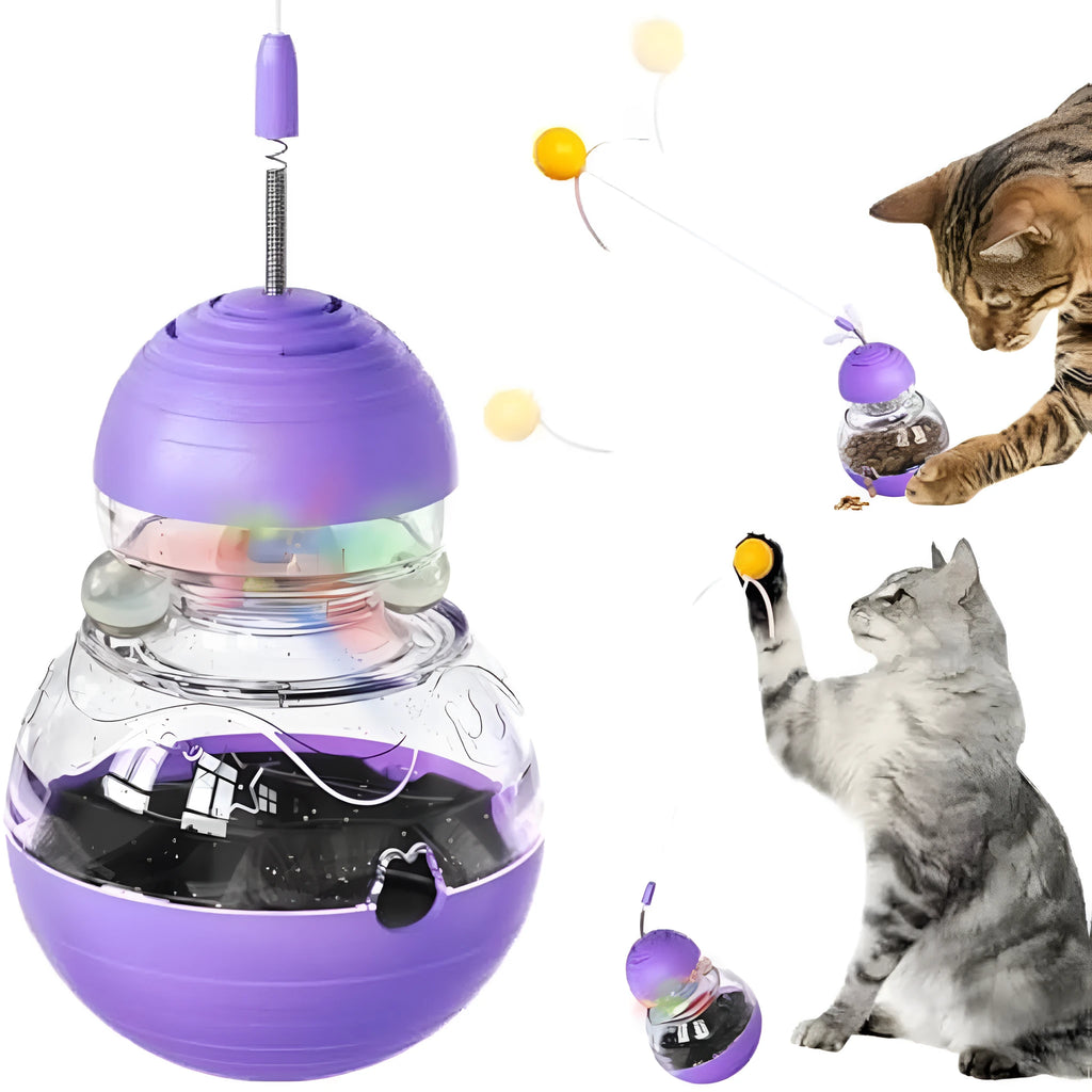 Colourful cat wand toy with ribbon ball teaser and rocking food dispenser base on a wooden floor.