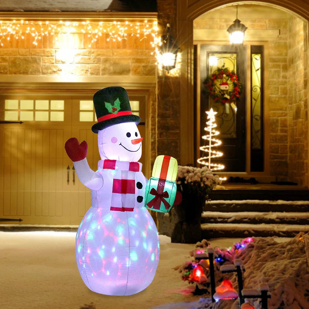 Illuminated Christmas inflatable decorations including Santa, snowman, and Christmas tree in a festive outdoor scene