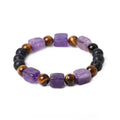 Rectangular volcanic stone bracelet in amethyst, red, brown, green, or blue colour on a wrist.