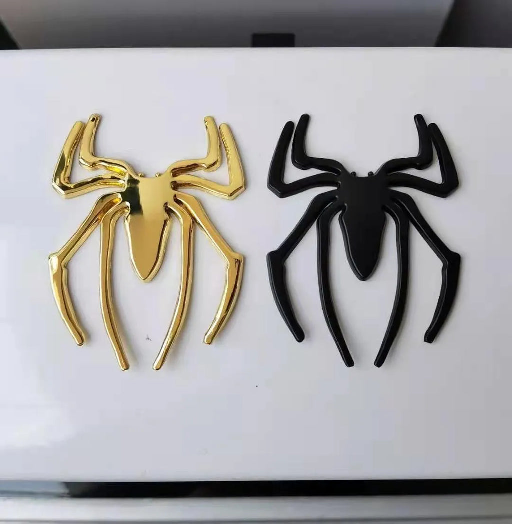 Three-dimensional metal spider bumper sticker in metallic finish.