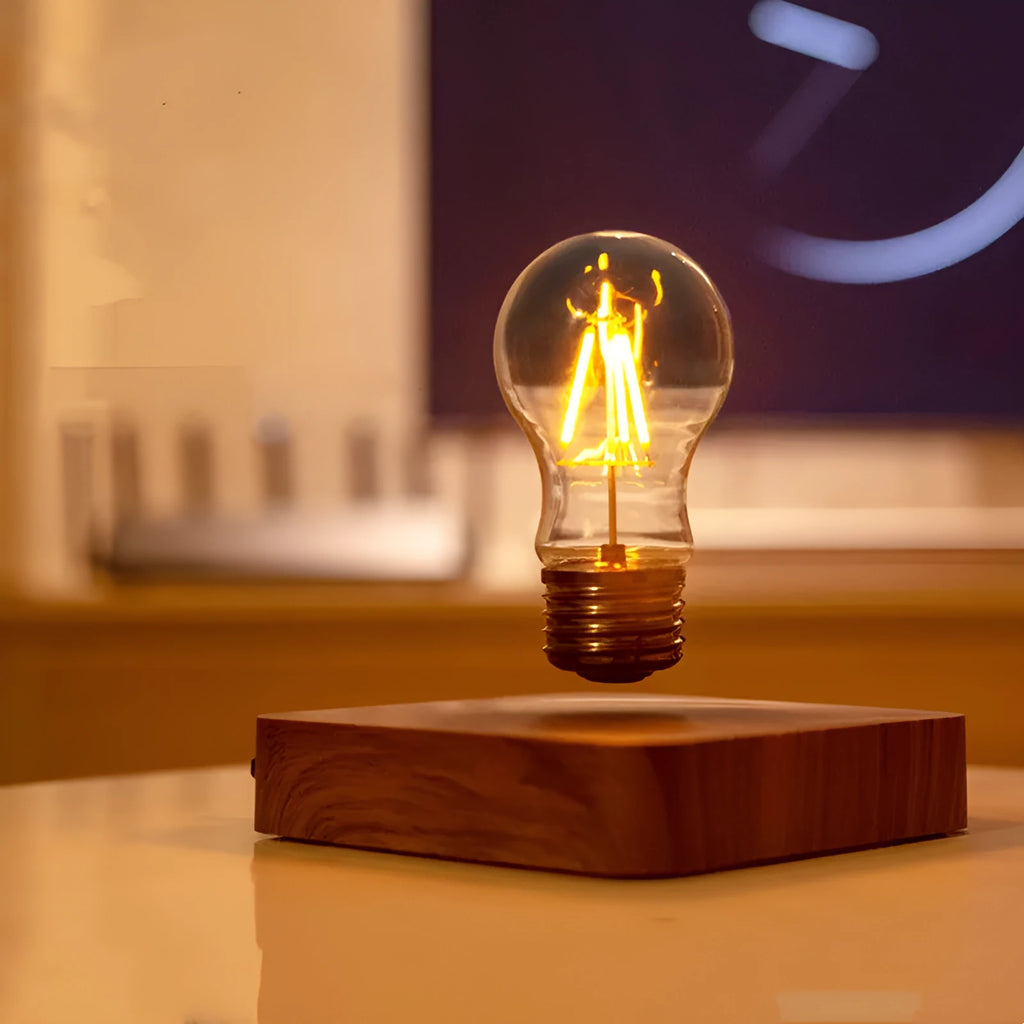 Self-rotating wireless powered maglev bulb with warm yellow light on a compact ABS base