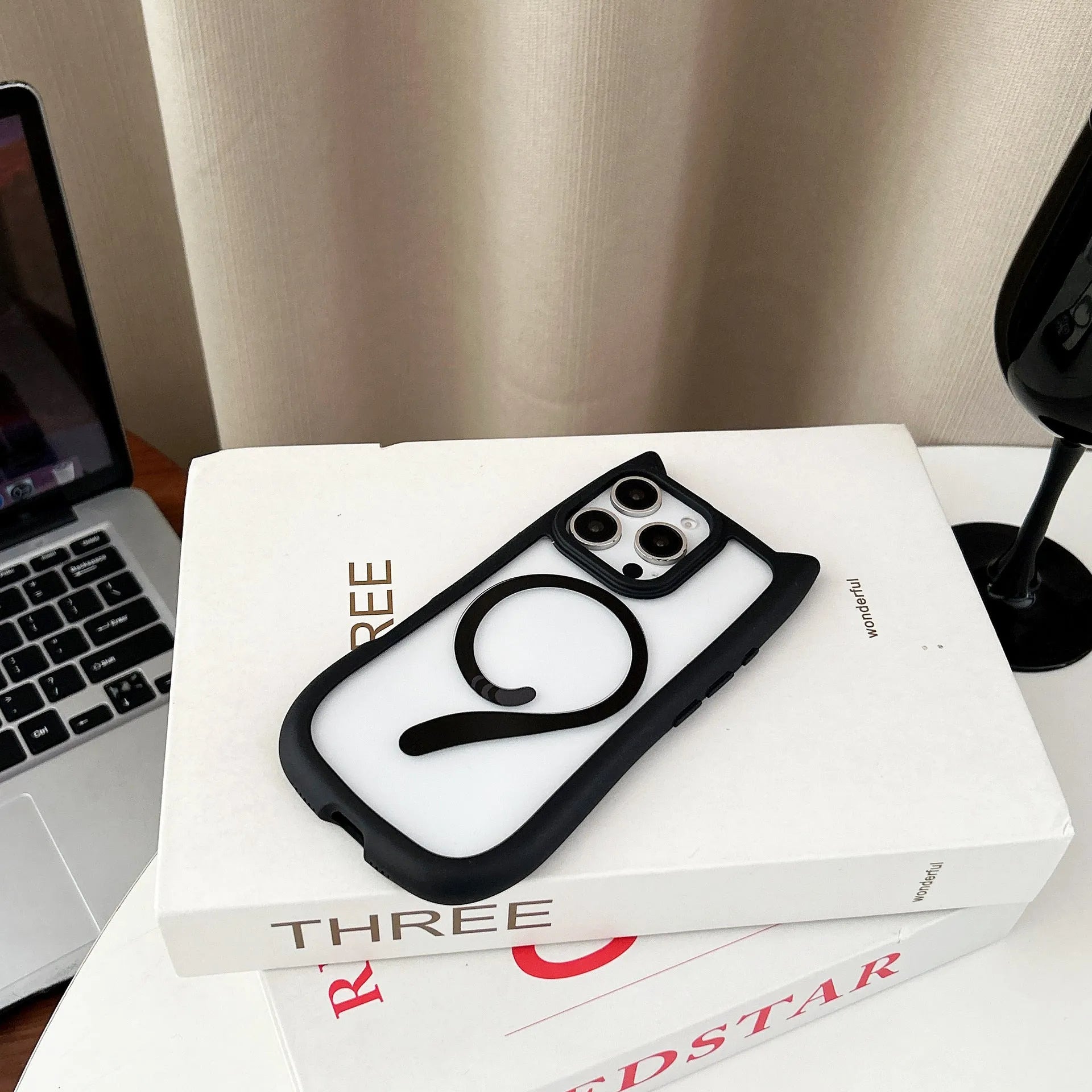Transparent acrylic and black TPU phone case for iPhone 17 with a removable airbag component.