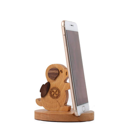 Custom lettering beech wood lazy phone holder with coin slot on a wooden table