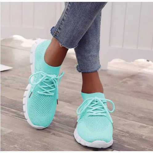 Women's high-cut lace-up sneaker in a choice of colours, showing breathable upper and flat rubber sole.