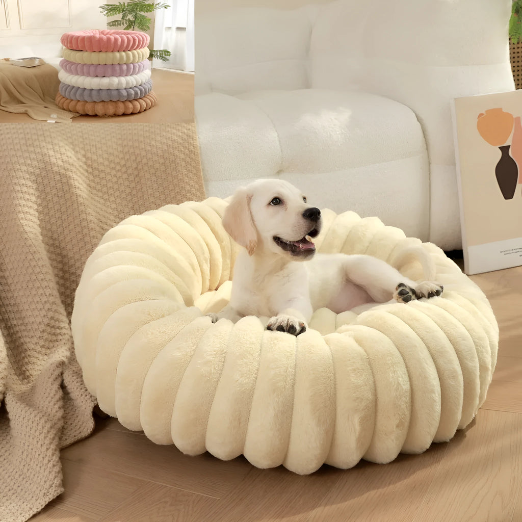 Round long-haired plush pet bed for dogs and cats, shown in beige, with size chart showing S, M, L, XL, XXL, XXXL options.