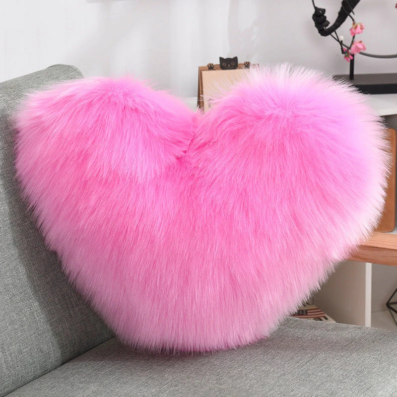 Plush heart-shaped throw pillows in various colors and styles for cozy sofa decor