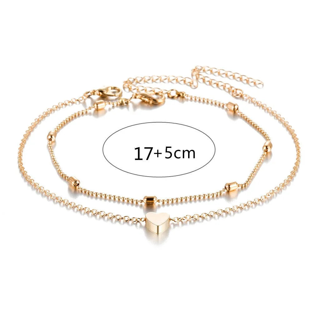 Double-layered retro beach ball chain heart-shaped alloy anklet in gold colour on white background