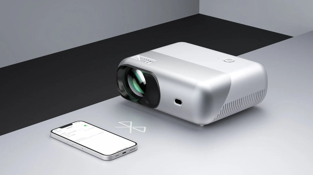 White portable WiFi HD 1080p projector with focus ring and remote control on a table