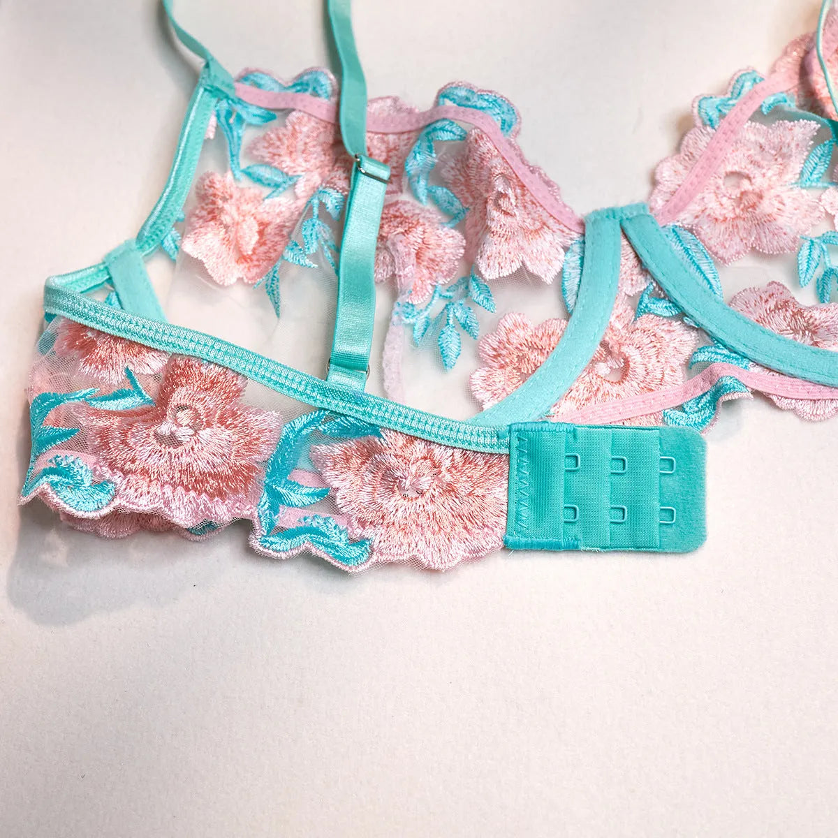 Pink women's bikini set with embroidery detail and a matching sheer mesh pettiskirt skirt.