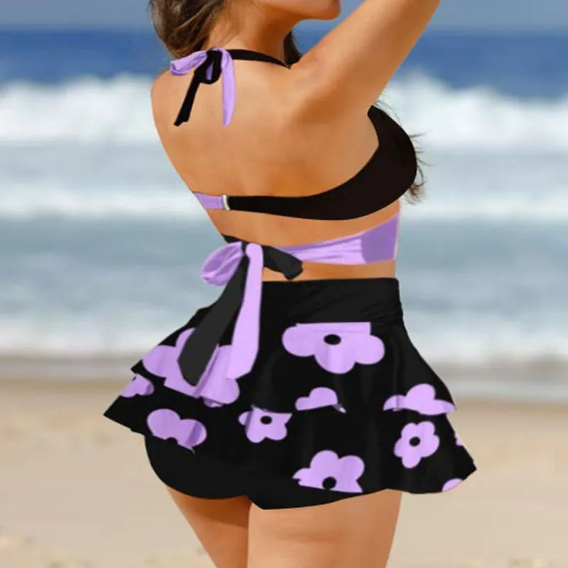 Women's purple bikini swimsuit with matching skirt showing lace-up design and high-waist brief style