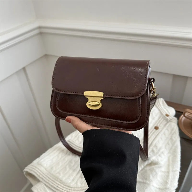 Small soft PU leather square handbag in retro design, shown in a neutral colour.