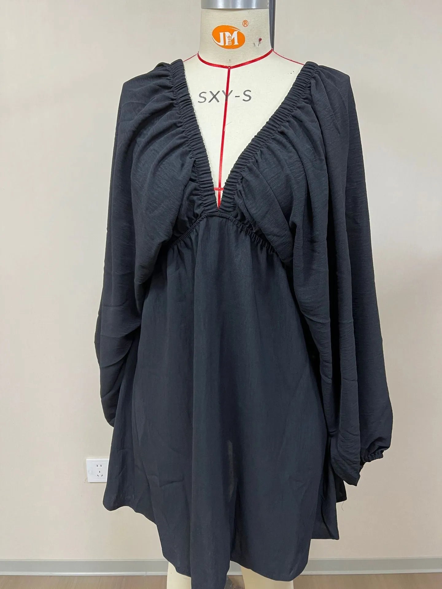Women's apricot V-neck dress with long puff sleeves and a flounced swing skirt, mid-waist design.