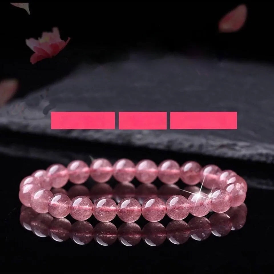 Women's strawberry quartz crystal bracelet showing polished natural stones in 6mm, 8mm or 10mm bead sizes