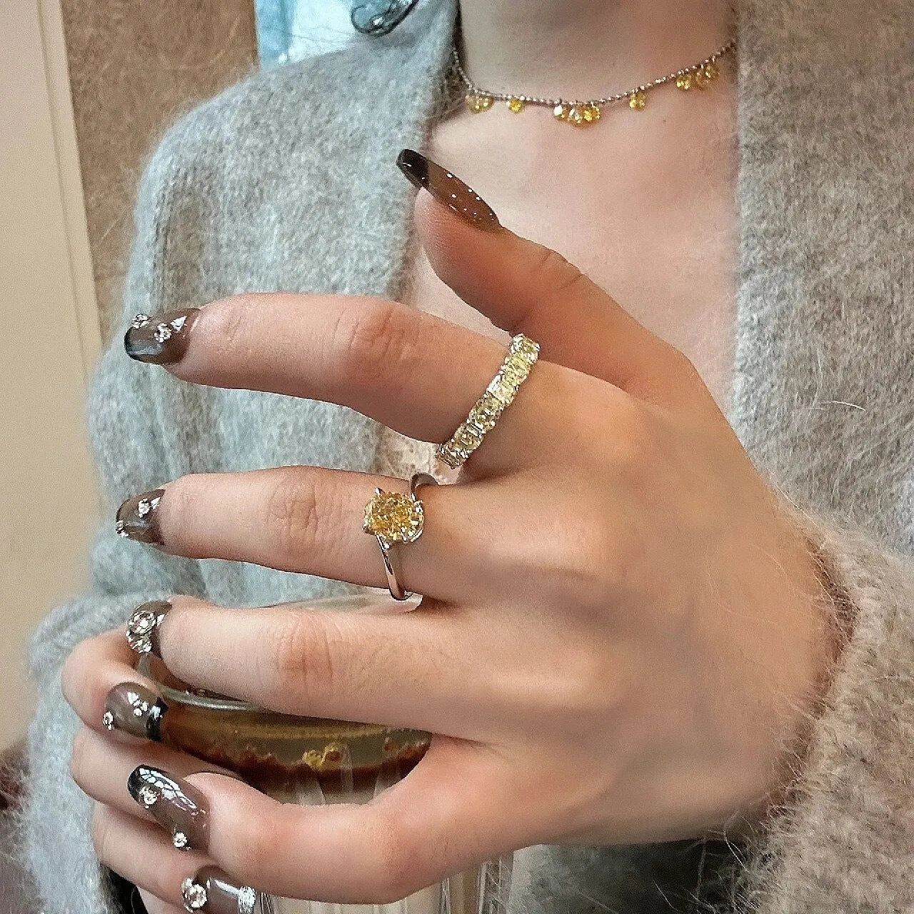 Yellow rock sugar crystal colour copper ring for women on a ring stand.