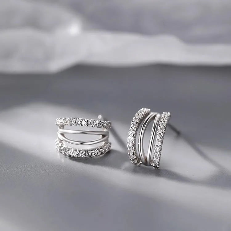 A pair of geometric-style earrings made from 925 silver with an electroplated finish, shown in large, medium, and small size options.