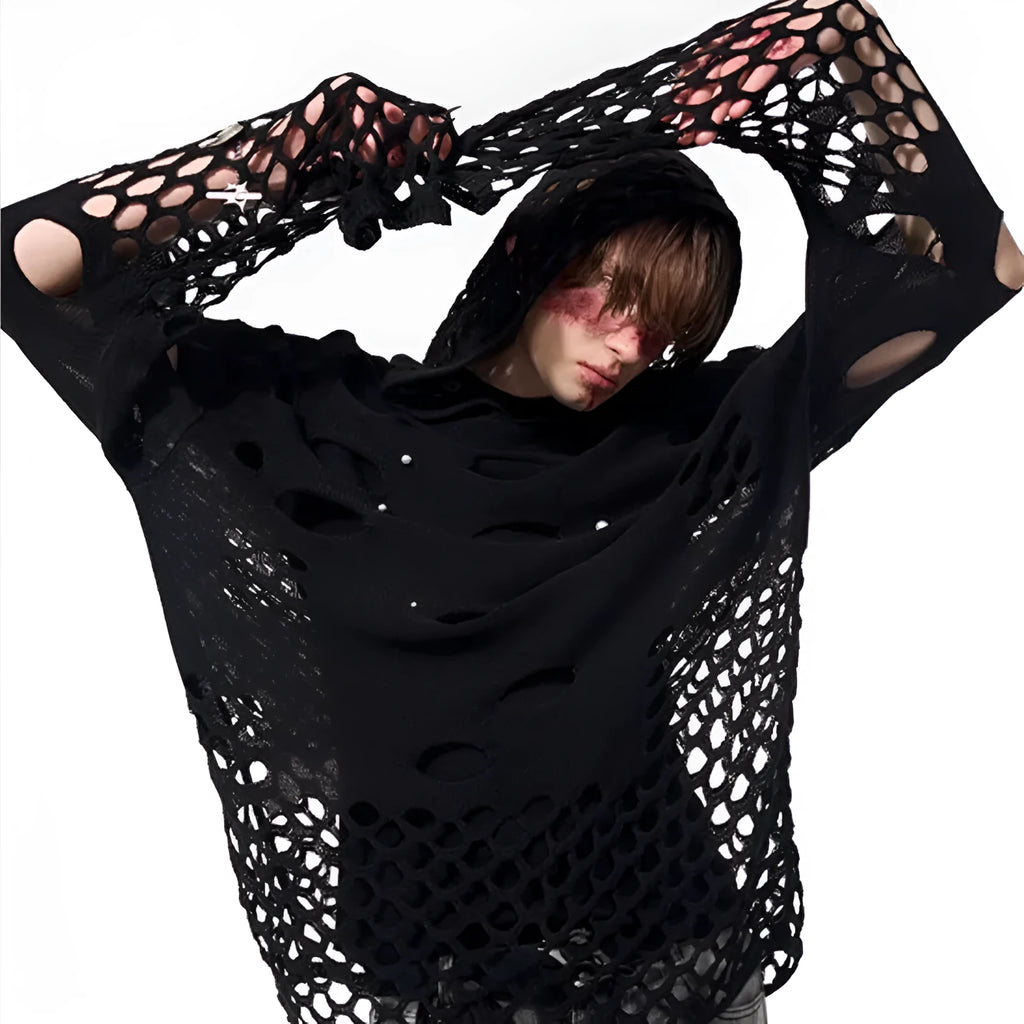 Man wearing a black loose-fit hollow knit hoodie with pearl decorations on the hood.