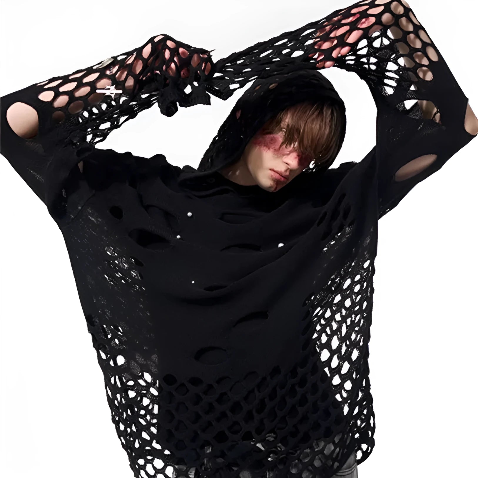 Man wearing a black loose-fit hollow knit hoodie with pearl decorations on the hood.