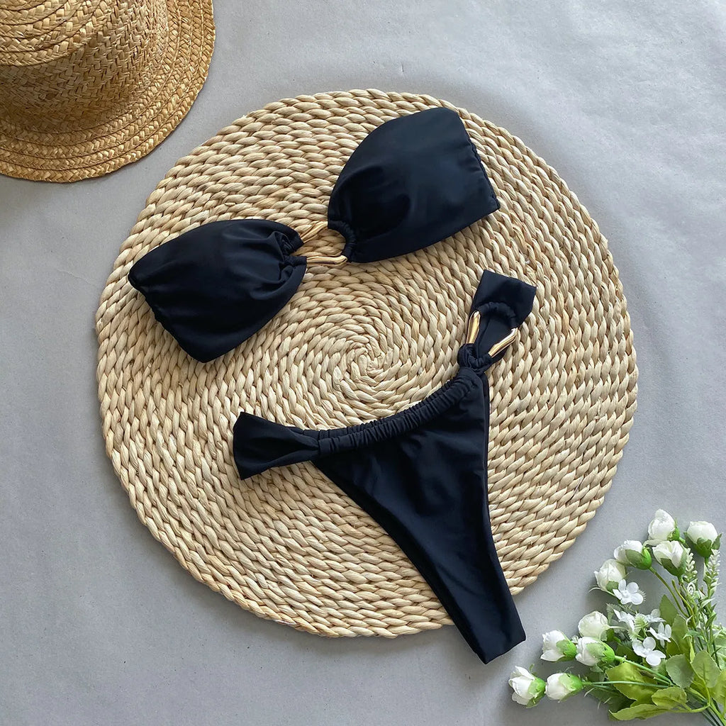 Black low waist split style women's bikini swimsuit on a white background