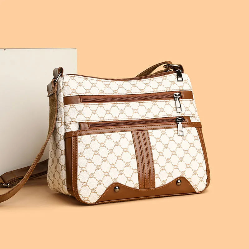 Brown women's crossbody bag with stitching pattern detailing and large storage capacity