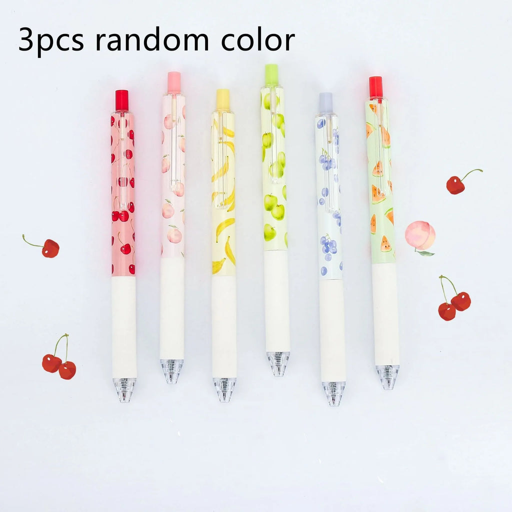 Three scented fruit ballpoint pens with press-action mechanism showing extended writing tips