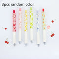 Three scented fruit ballpoint pens with press-action mechanism showing extended writing tips