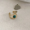 Titanium steel geometric open ring with natural green stone centrepiece on alloy band