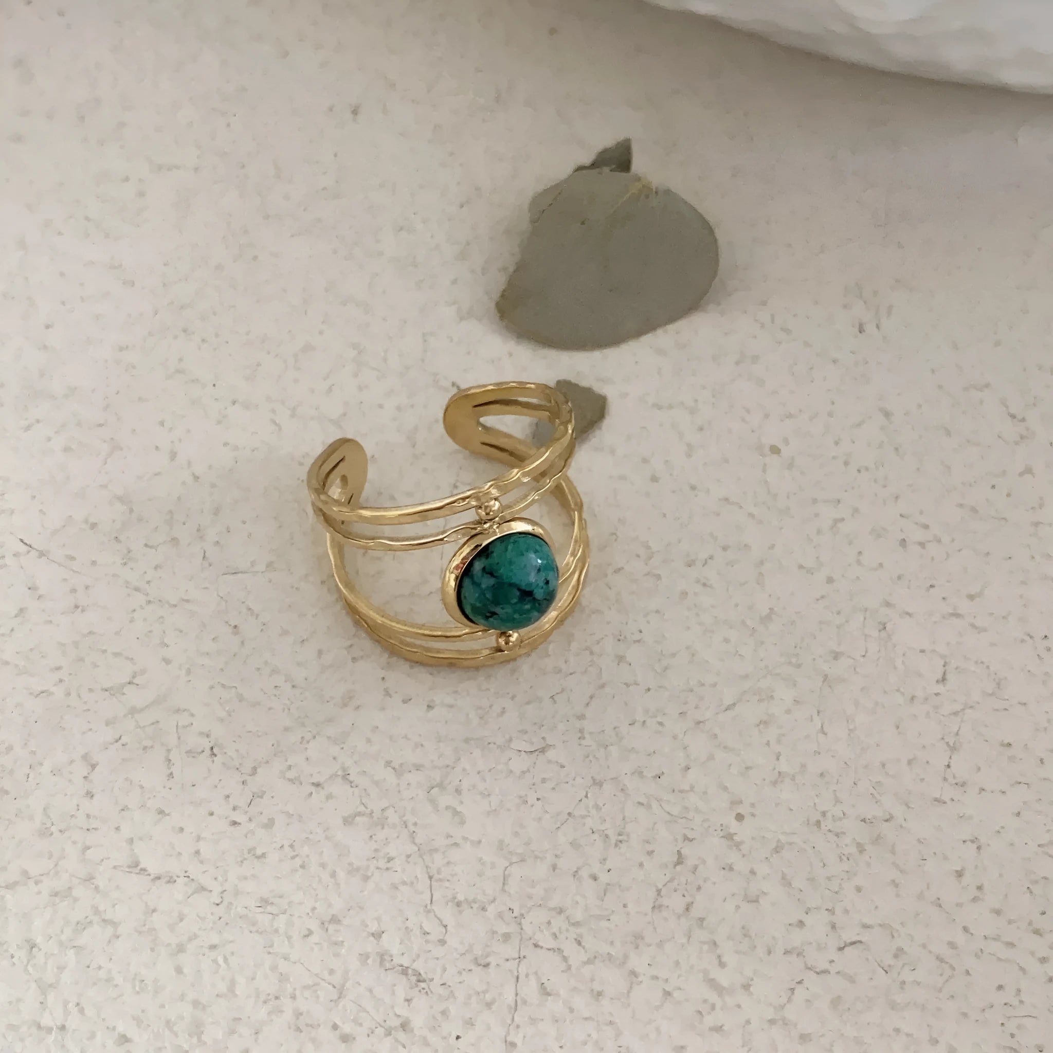 Titanium steel geometric open ring with natural green stone centrepiece on alloy band