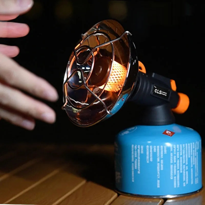Black and orange portable outdoor gas heating stove with piezo ignition on a table
