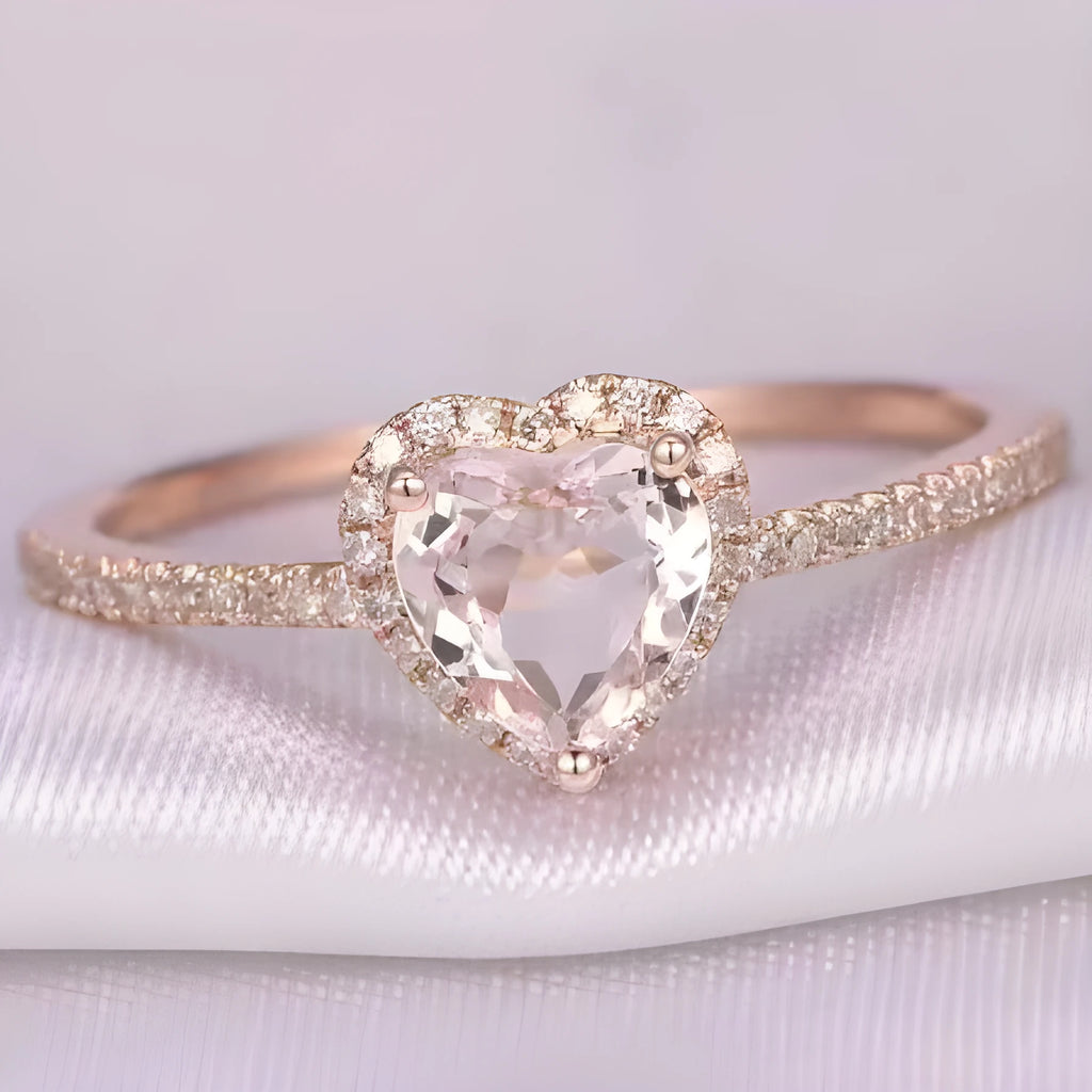 Women's heart-shaped wedding ring with central crystal on white copper band in rose gold finish.
