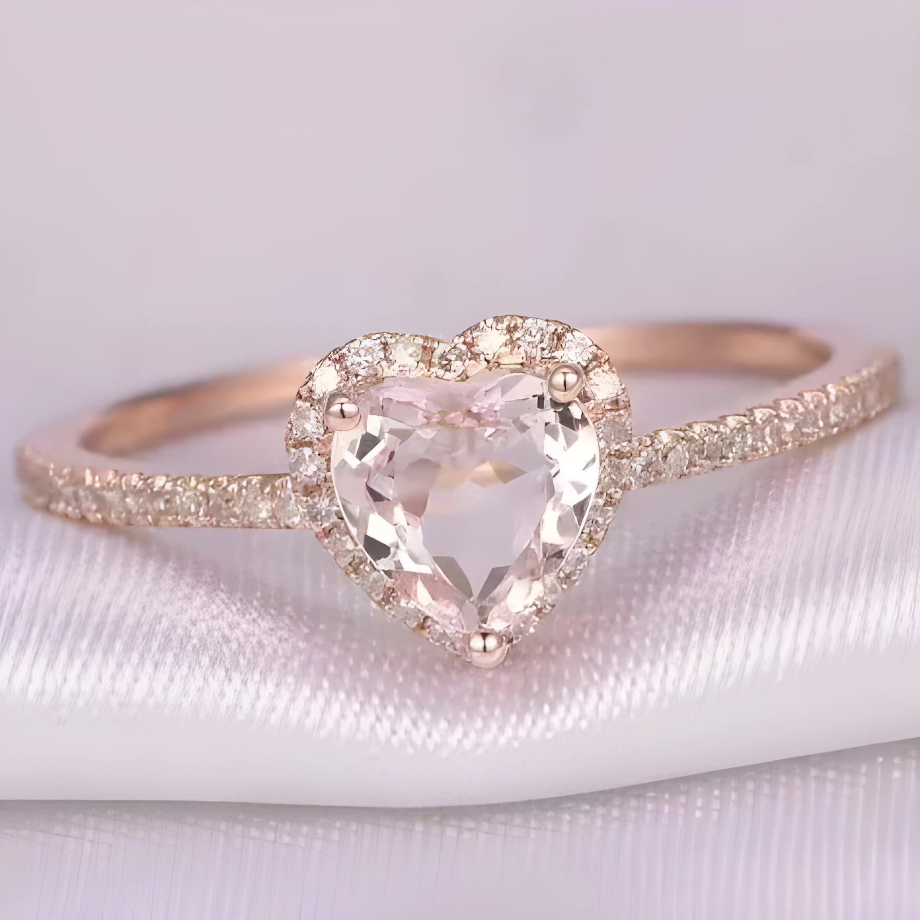 Women's heart-shaped wedding ring with central crystal on white copper band in rose gold finish.