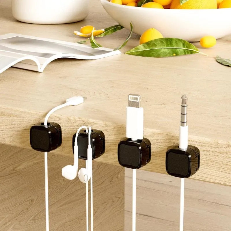 Black and white magnetic cable clips with adhesive backing for under desk wire organisation
