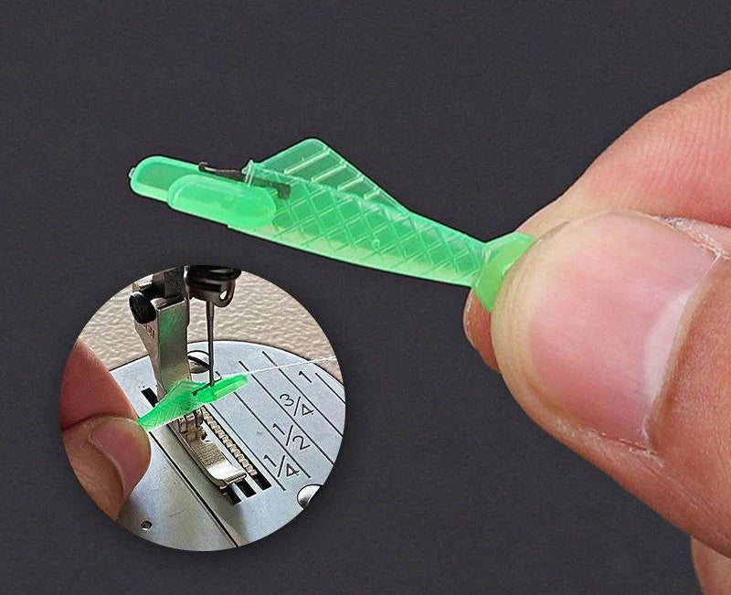 Small fish design needle threader for sewing machines in green, metal and plastic construction