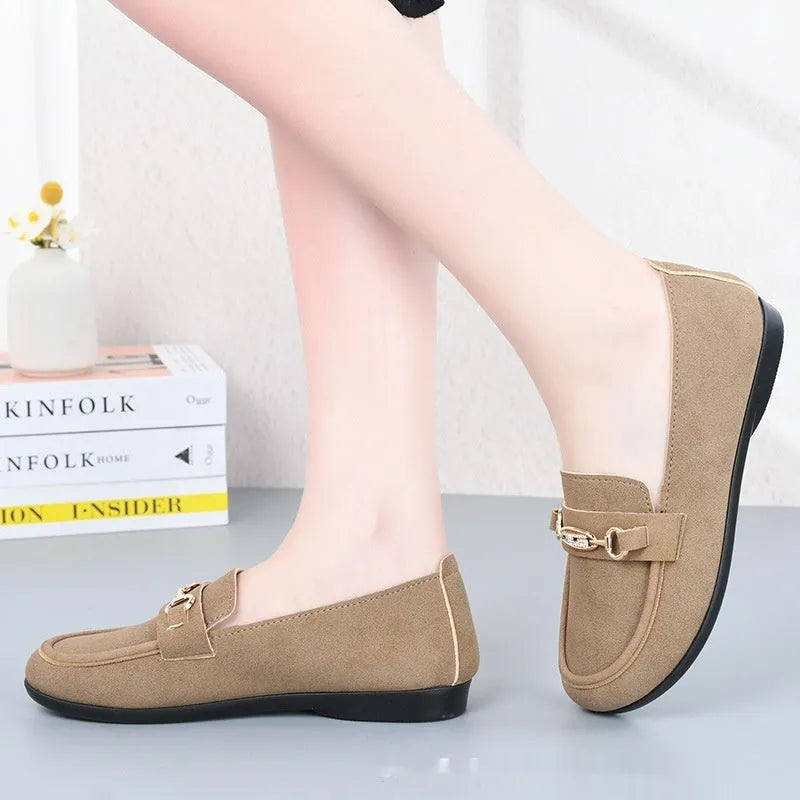 Gommino women's black casual slip-on shoes with round toe and flat rubber sole on a white background.
