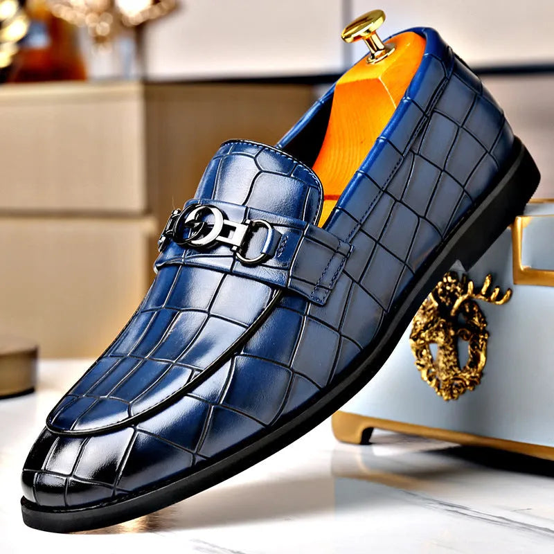 Men's casual leather shoes with embossed horsebit buckle in black, side view showing flat wedge heel and rubber sole