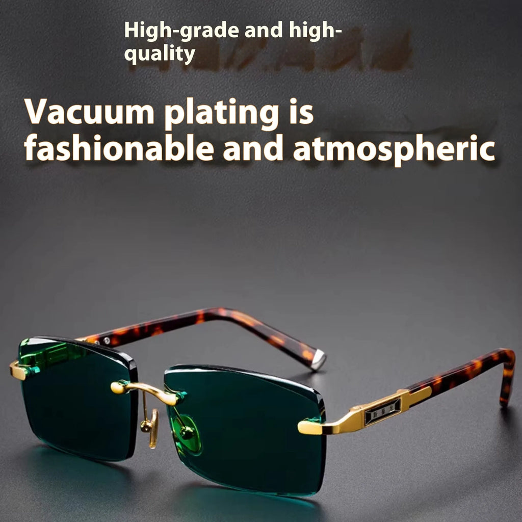 Dark green crystal frameless sunglasses with a case and cleaning cloth on a table.