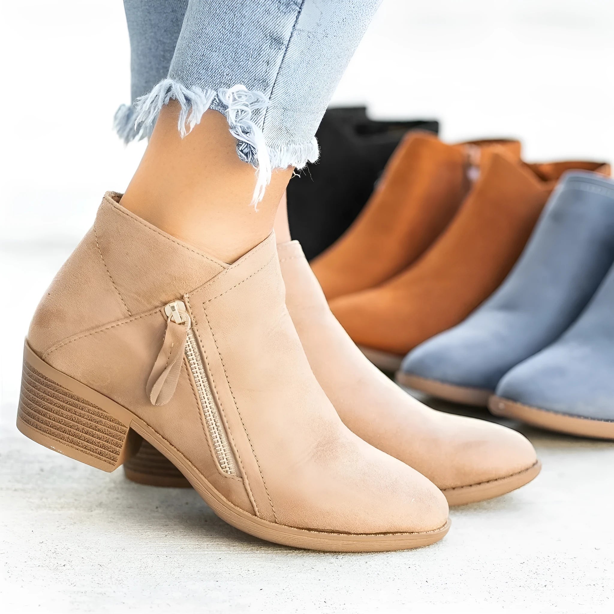 Women's suede chunky heel ankle boots with side zip in blue, shown from the side.