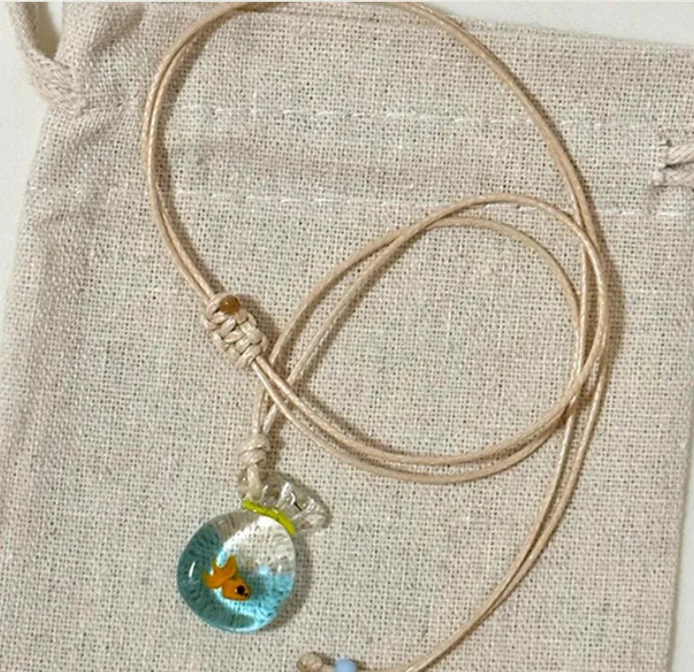 Women's skirt-shaped joker pendant necklace on a cotton and linen clavicle chain.