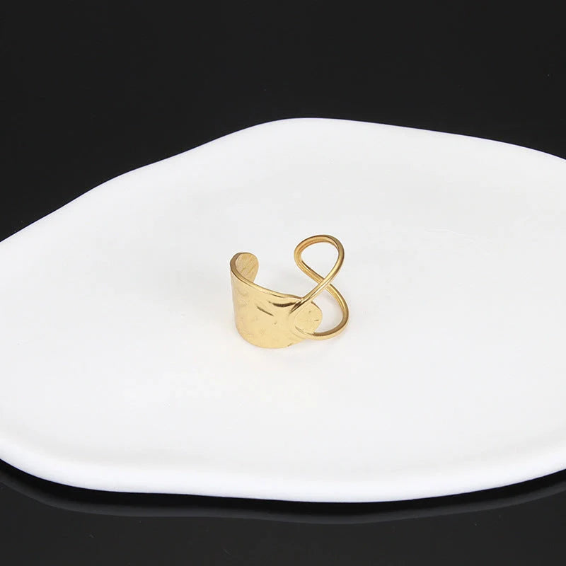 Adjustable stainless steel finger ring with unique charm designs in steel and gold colours