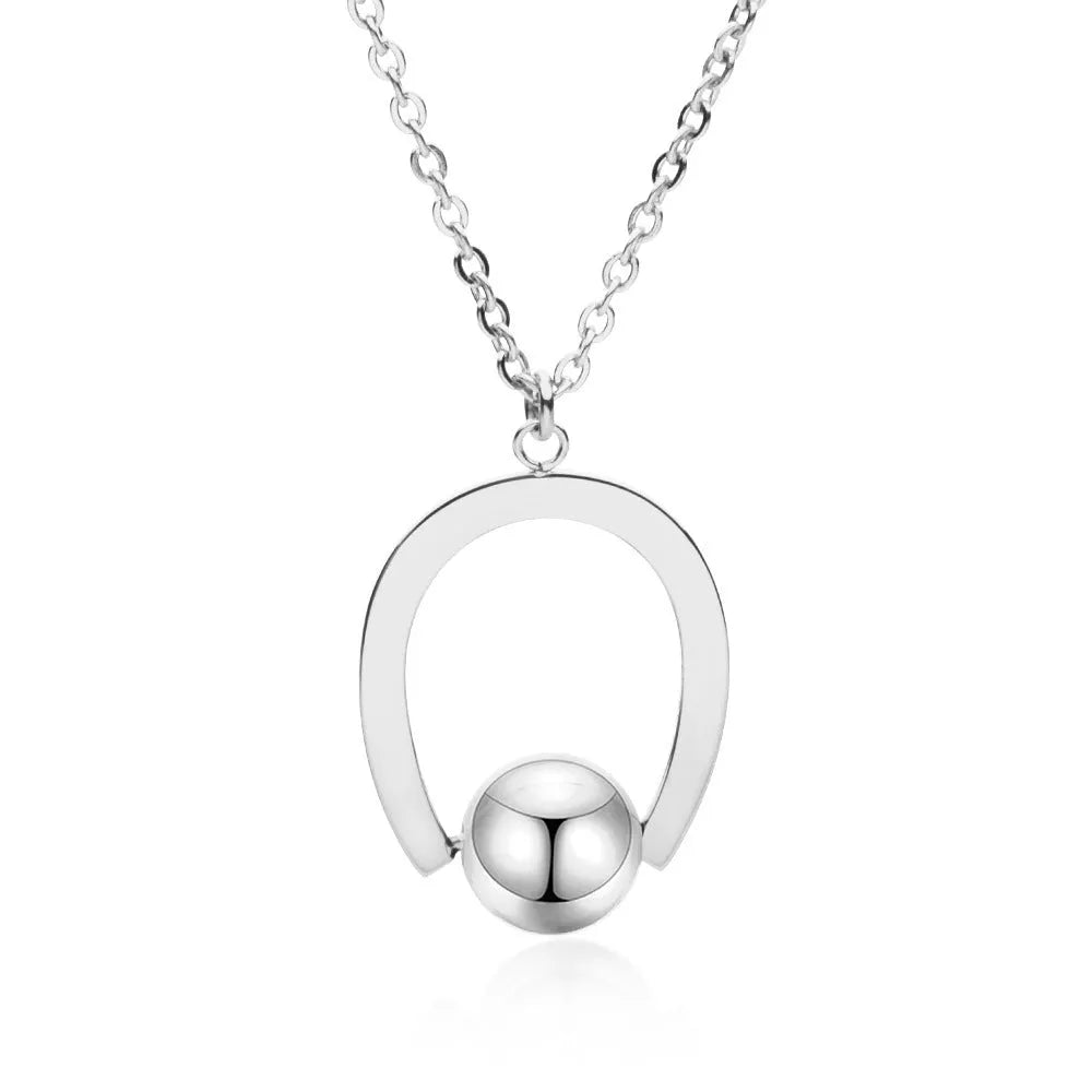 Stainless steel necklace with geometric pendant on a cross chain, shown in gold colour.