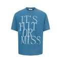 Man wearing a blue loose-fit cotton blend T-shirt with a retro white letter print design on the chest.