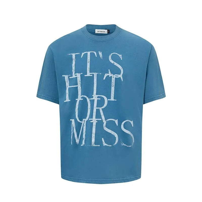 Man wearing a blue loose-fit cotton blend T-shirt with a retro white letter print design on the chest.