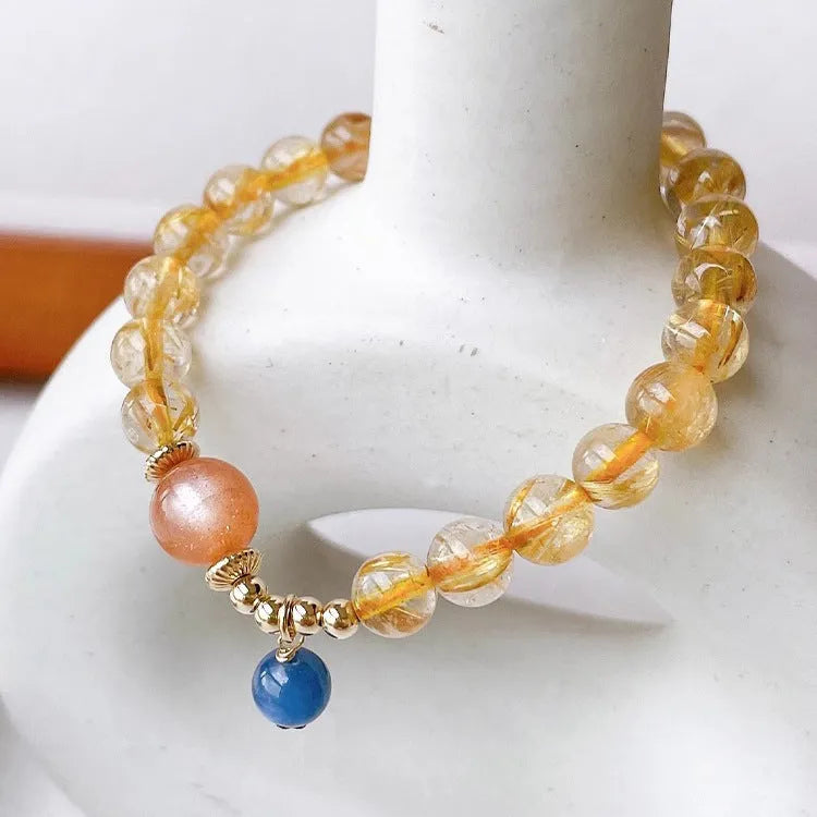 Gold rutilated quartz and sunstone bracelet with round diamond-cut beads for women