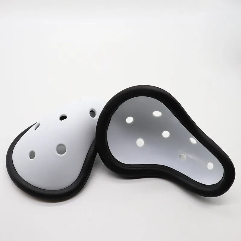 Black rubber sports genital protector for adult and child sizes used in hockey, rugby, and martial arts.