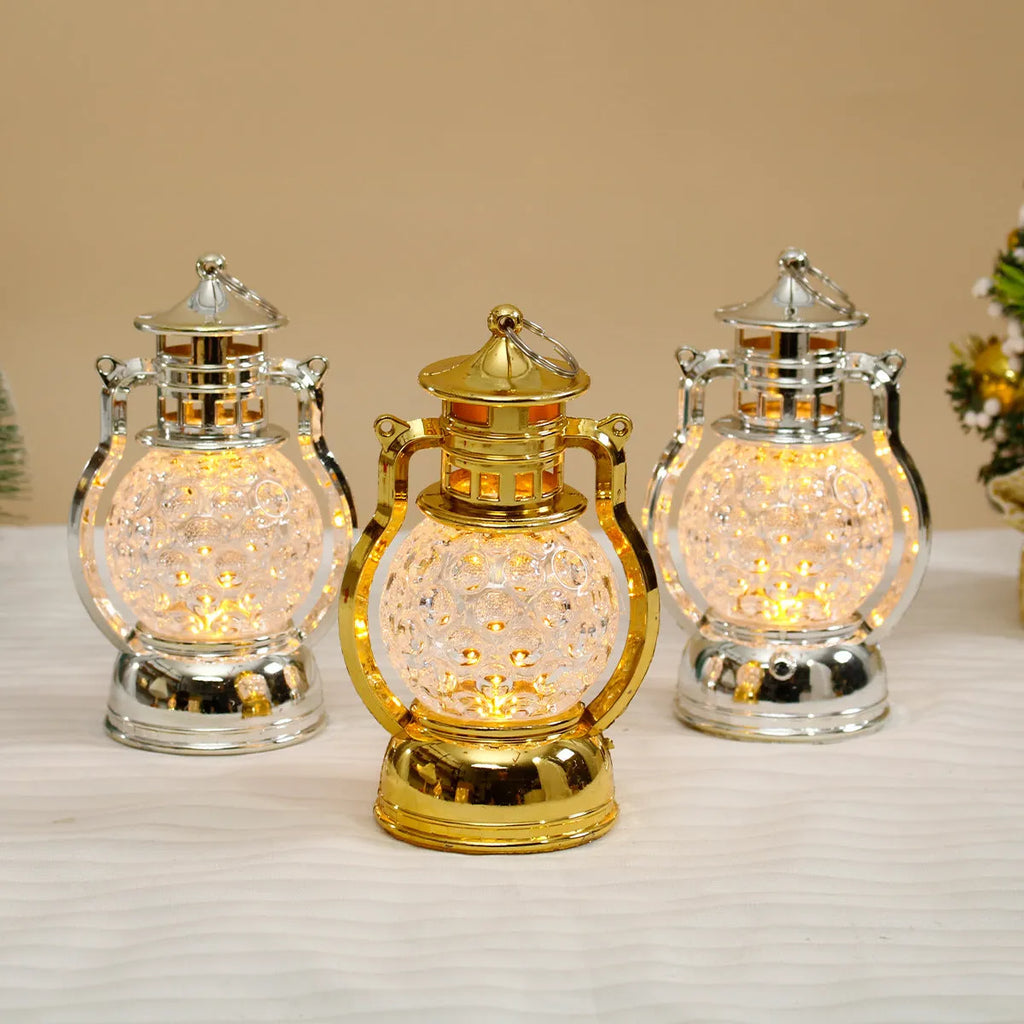 Creative retro-style oil lamp LED night light in gold or silver finish on a dark surface