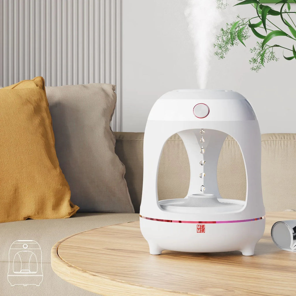 Rose gold and white columnar humidifier with levitating water drops and LED glow on a desk